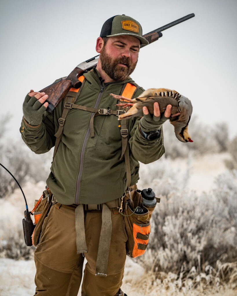 Ben Brettingen holding a chukar.