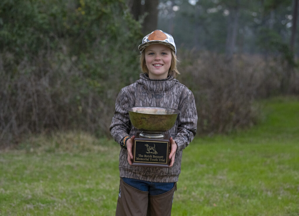 A youth holding a trophy.